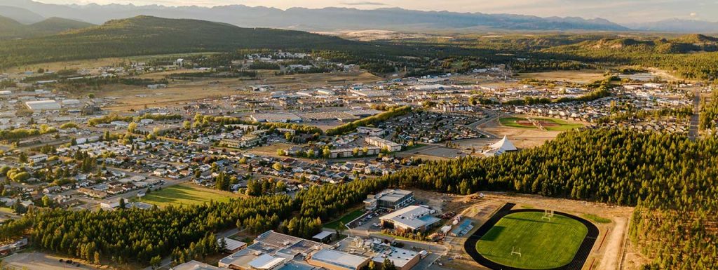 A panoramic view of Cranbrook, BC, surrounded by the Rocky Mountains and lush valleys — a tourism photo showcasing the city’s natural beauty. Photo: Visit Cranbrook
