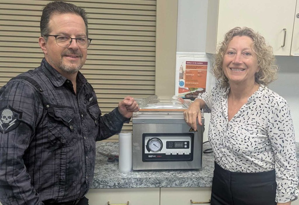 Event coordinator Lorelei Fiset of Pinnacle Communications and Media, along with Jay from the community hall kitchen, show off the new vacuum sealer at the Village of Lumby’s first Seniors Wellness and Food Fair, held Oct. 21 at the White Valley Community Centre. This new equipment helps promote food preservation and wellness among the community.