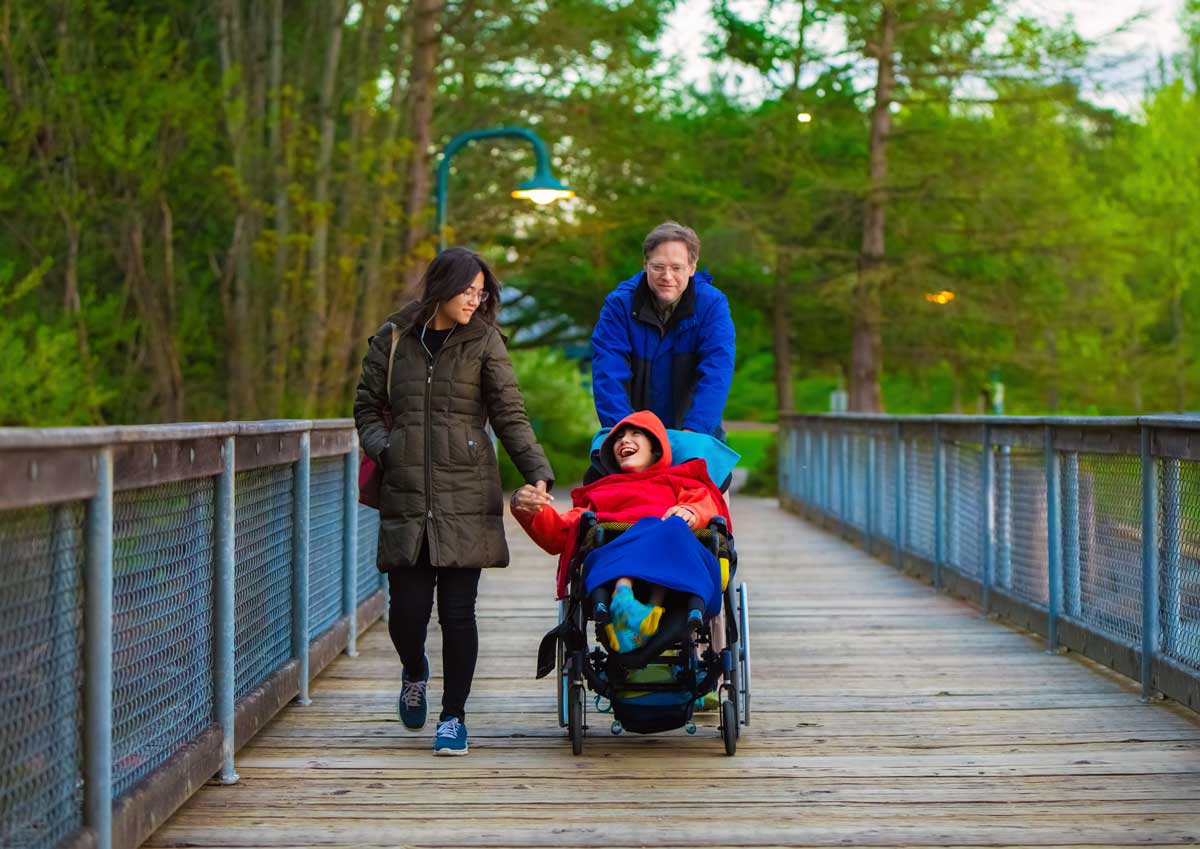 child with disablity crossing a footbridge